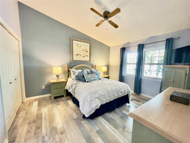 bedroom with lofted ceiling, light hardwood / wood-style flooring, and ceiling fan