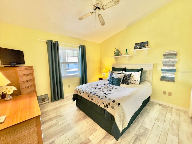 bedroom featuring vaulted ceiling, ceiling fan, and light wood-type flooring