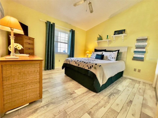 bedroom with lofted ceiling, hardwood / wood-style floors, and ceiling fan