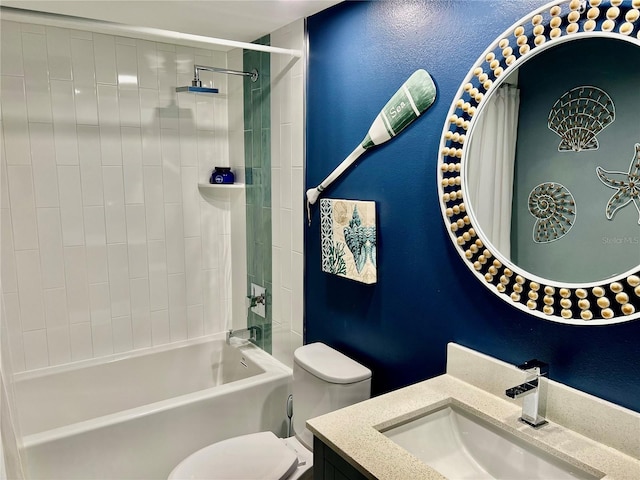 full bathroom with tiled shower / bath, vanity, and toilet