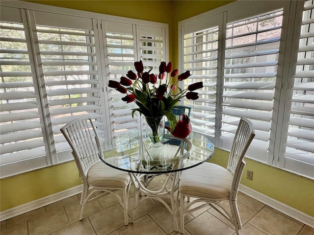 tiled dining room featuring plenty of natural light