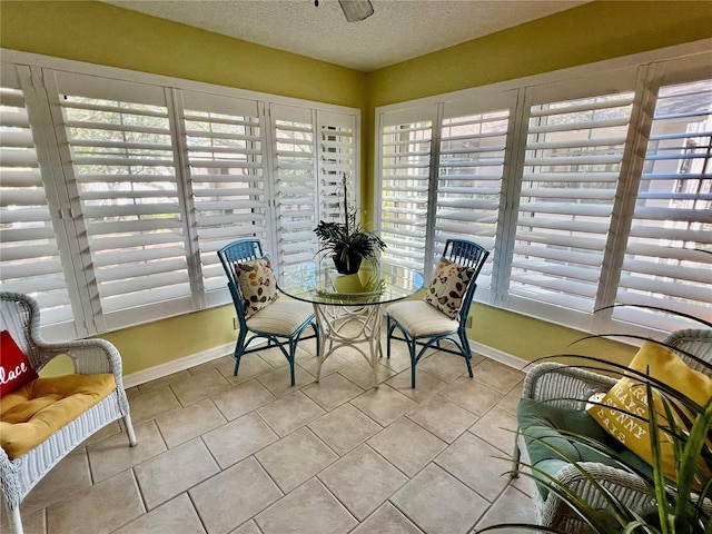 sunroom / solarium featuring ceiling fan