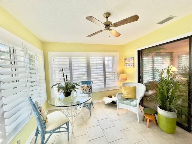 sunroom / solarium featuring ceiling fan