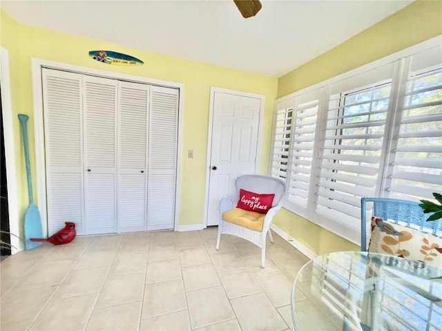 sitting room with ceiling fan and light tile patterned floors