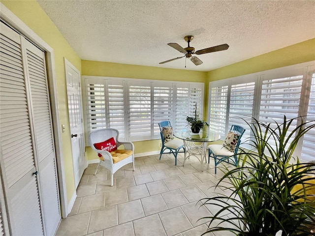 sunroom featuring ceiling fan