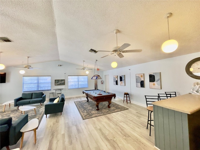 rec room featuring lofted ceiling, pool table, light hardwood / wood-style flooring, and a textured ceiling