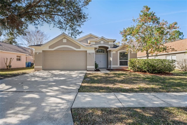 single story home featuring a garage and a front yard