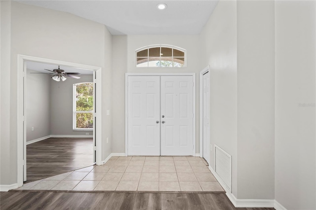 tiled entrance foyer featuring ceiling fan