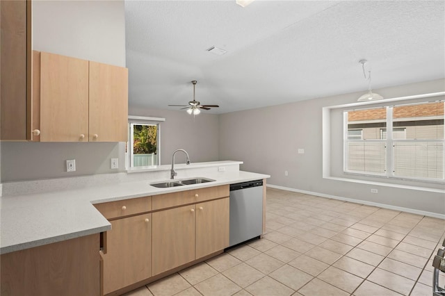 kitchen with pendant lighting, sink, stainless steel dishwasher, and light brown cabinets