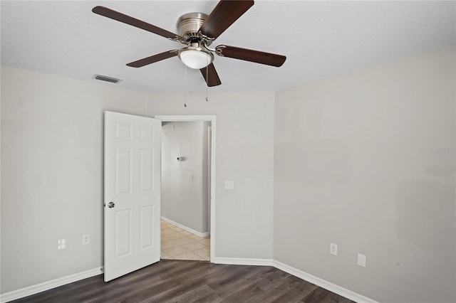 unfurnished room featuring dark hardwood / wood-style floors and a textured ceiling