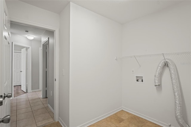 clothes washing area featuring hookup for a washing machine and light tile patterned floors