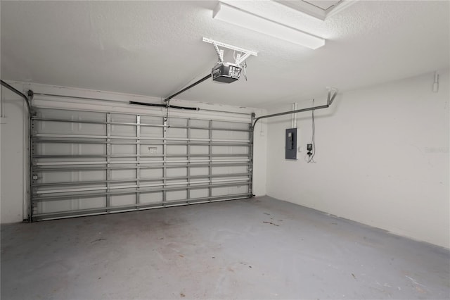 garage with a garage door opener and electric panel