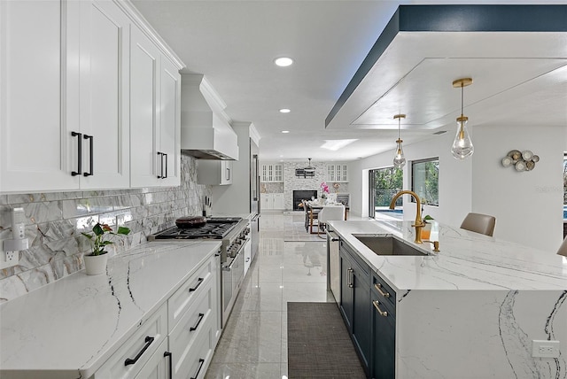 kitchen featuring pendant lighting, sink, white cabinets, and appliances with stainless steel finishes