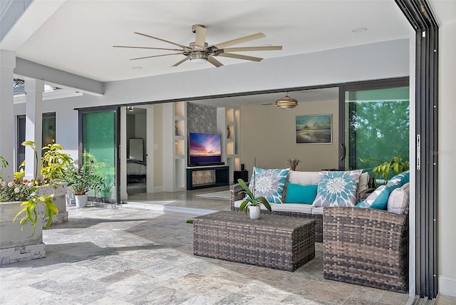 view of patio featuring an outdoor living space and ceiling fan