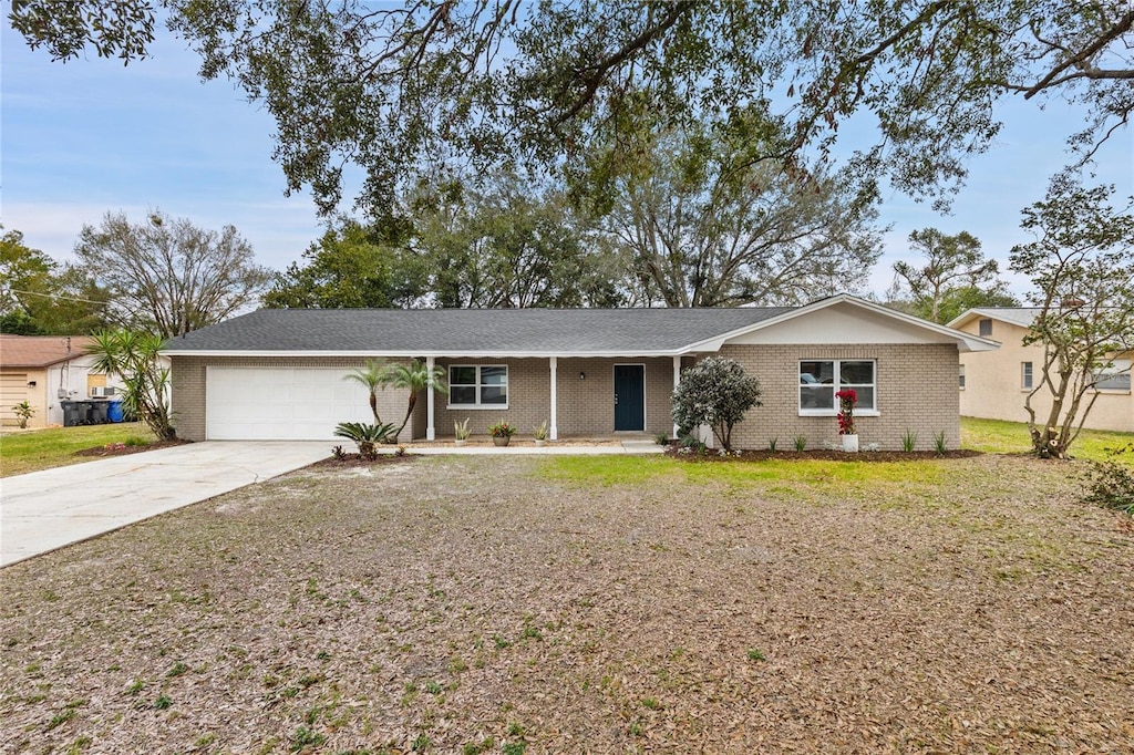 ranch-style home featuring a garage and a front yard