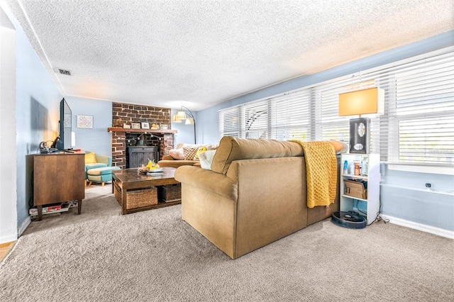 living area with a textured ceiling, a brick fireplace, visible vents, and light colored carpet