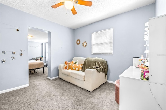 carpeted bedroom featuring ceiling fan, a textured ceiling, and baseboards