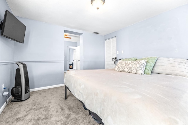 bedroom with carpet floors, a closet, visible vents, and baseboards