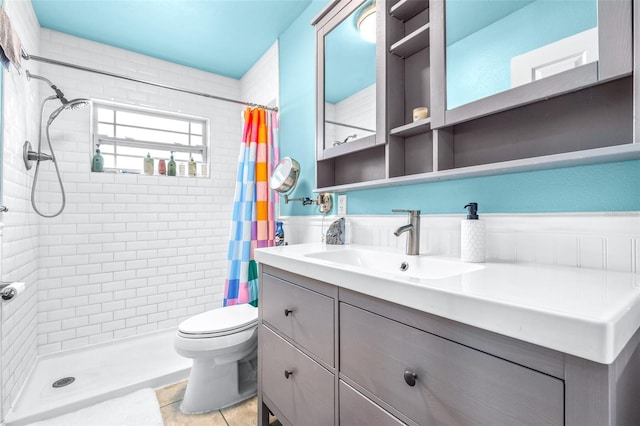 full bathroom with a shower stall, vanity, toilet, and tile patterned floors