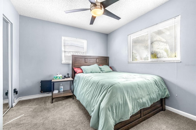 bedroom featuring a textured ceiling, ceiling fan, carpet, and baseboards