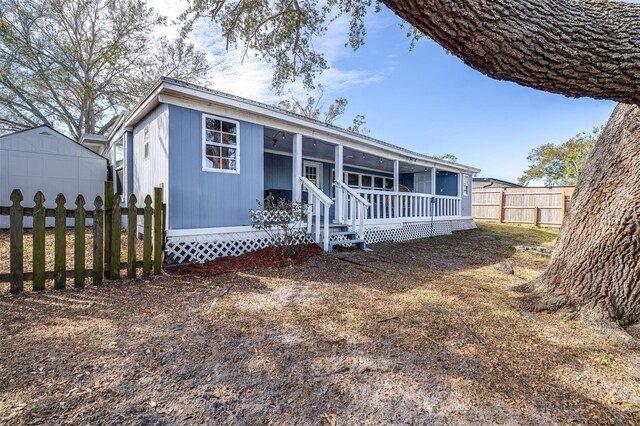 view of front of house with a porch and fence