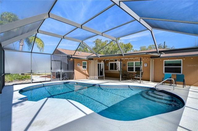 view of swimming pool featuring a patio and glass enclosure