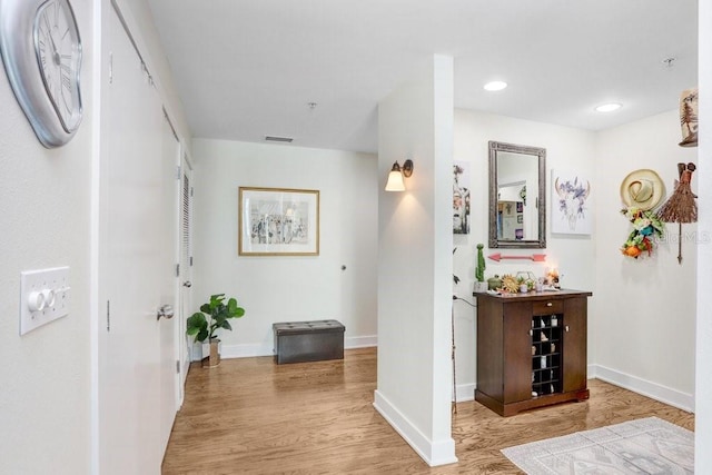 corridor with light hardwood / wood-style flooring