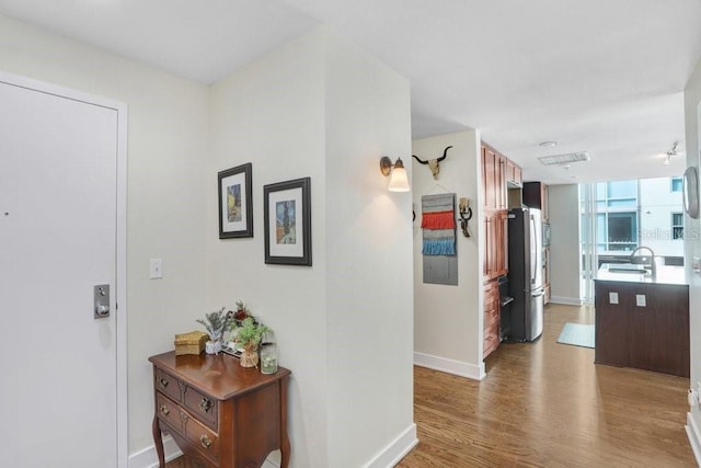 hallway with dark hardwood / wood-style flooring and sink