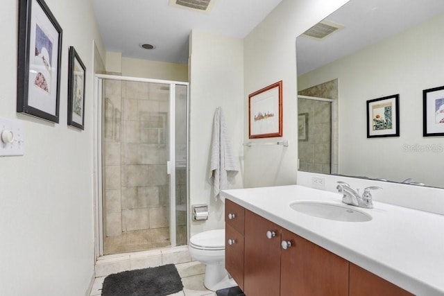 bathroom featuring vanity, toilet, an enclosed shower, and tile patterned flooring