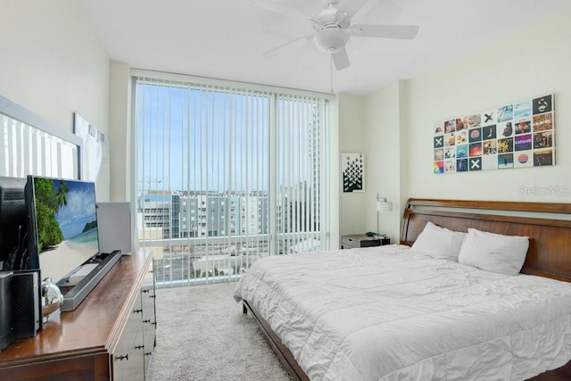 bedroom with expansive windows, carpet floors, and ceiling fan