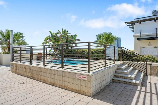 view of patio featuring a community pool