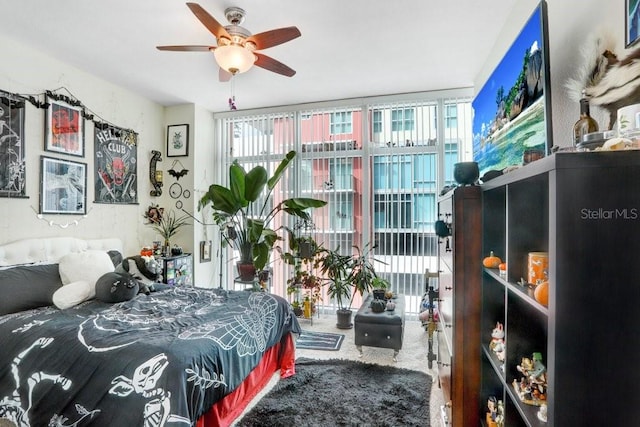 bedroom featuring ceiling fan, carpet, and multiple windows