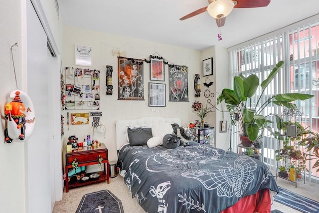 bedroom with ceiling fan, carpet flooring, and a closet