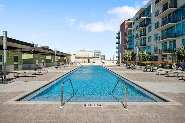 view of swimming pool featuring a patio area