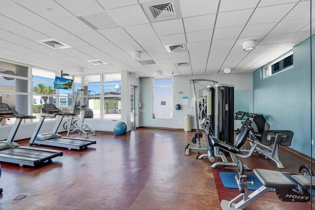 exercise room featuring a drop ceiling and plenty of natural light