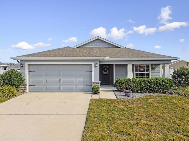 ranch-style home featuring a garage and a front lawn