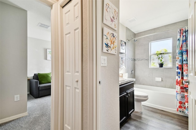 full bathroom with vanity, hardwood / wood-style floors, toilet, and shower / tub combo with curtain