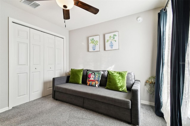 sitting room featuring ceiling fan and carpet