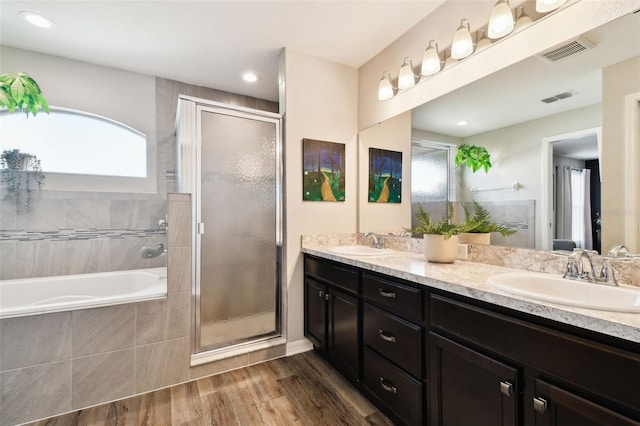 bathroom featuring vanity, hardwood / wood-style floors, shower with separate bathtub, and a healthy amount of sunlight