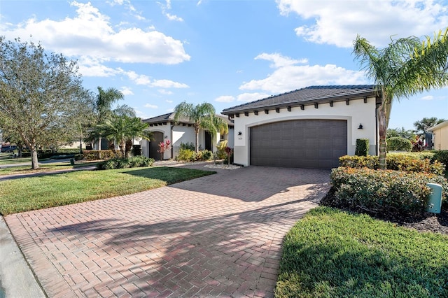 mediterranean / spanish home with a garage and a front yard