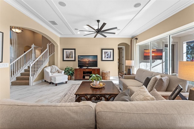 living room with ornamental molding and ceiling fan