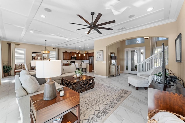 living room featuring french doors, ceiling fan, a healthy amount of sunlight, and coffered ceiling