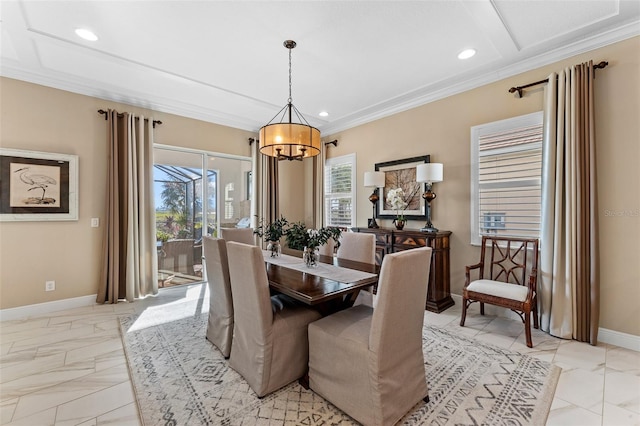 dining space featuring a notable chandelier, ornamental molding, and a healthy amount of sunlight