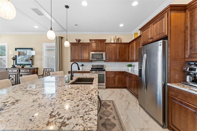 kitchen with stainless steel appliances, a kitchen bar, light stone countertops, and sink