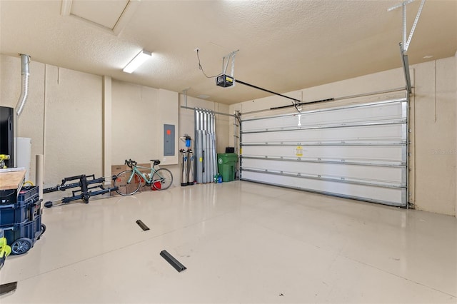 garage with a garage door opener and electric panel