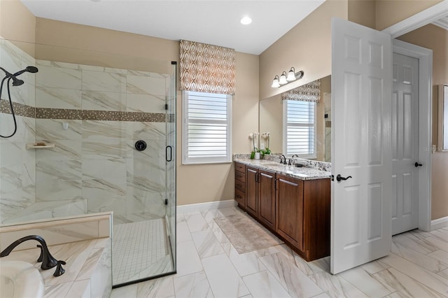 bathroom featuring vanity and a shower with door