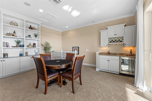 dining area with wine cooler, light carpet, ornamental molding, and indoor wet bar