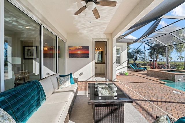 view of patio with an in ground hot tub, a lanai, and an outdoor hangout area