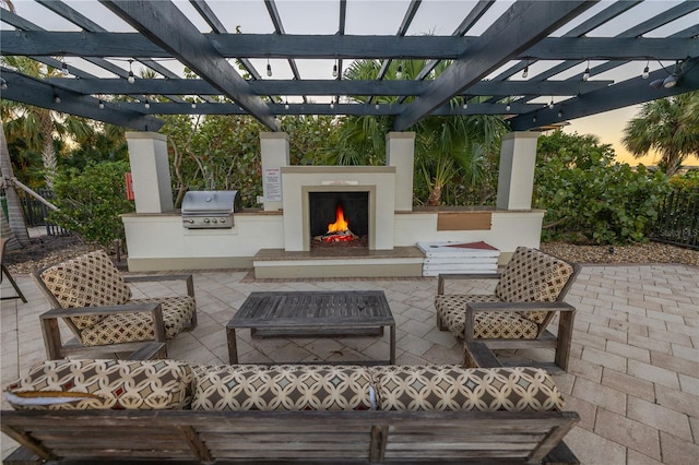 view of patio with exterior kitchen, an outdoor living space with a fireplace, area for grilling, and a pergola