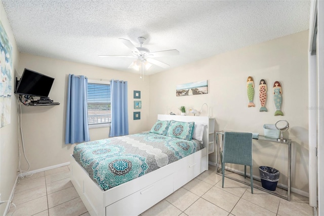 tiled bedroom with ceiling fan and a textured ceiling